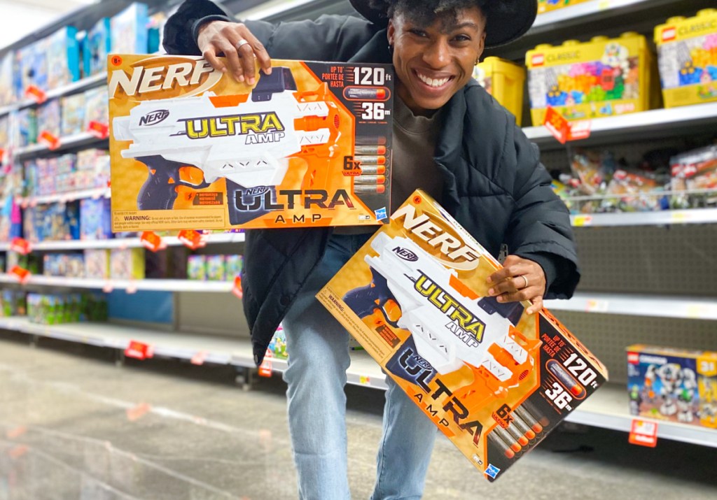 Person holding two NERF bundles