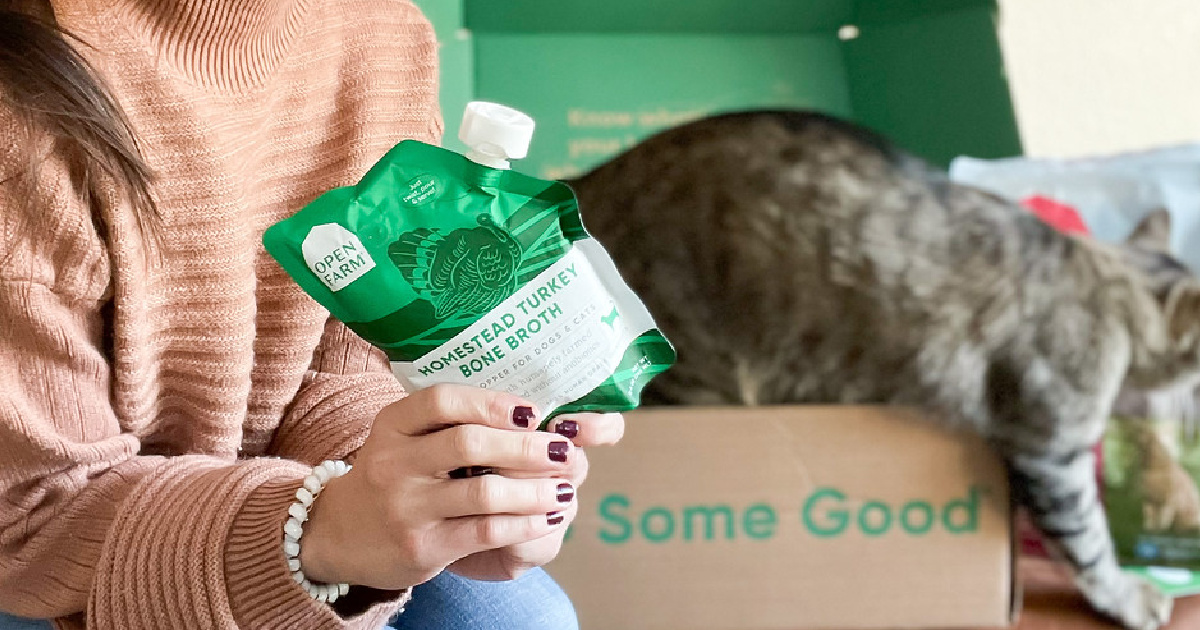 woman holding Open Farm Cat Bone Broth