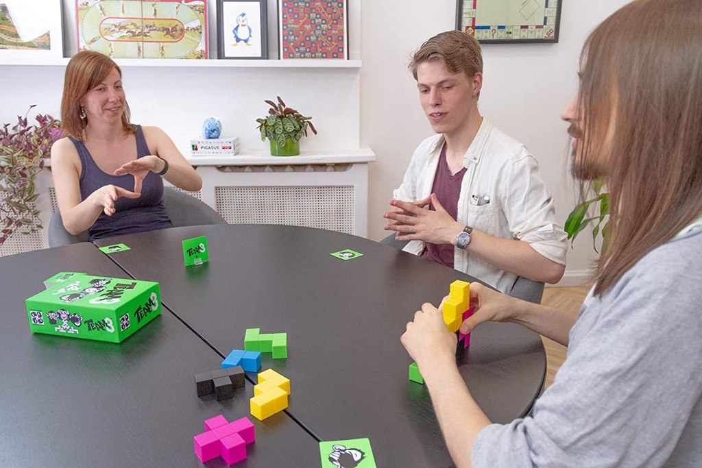 Teens playing Team3 Board Game