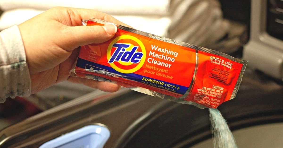 person pouring tide washing machine cleaner in washing machine