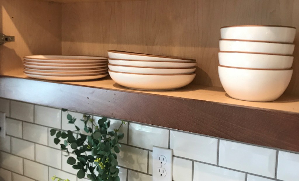 white plates stacked inside cabinet 