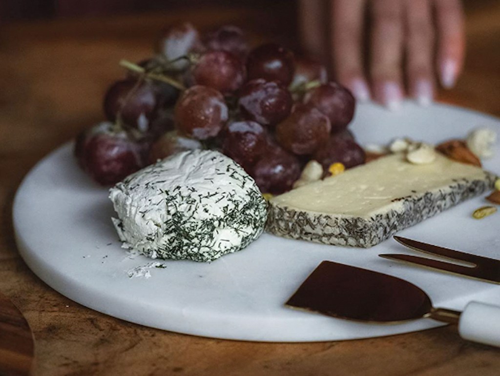 white marble tray with cheese and grapes 