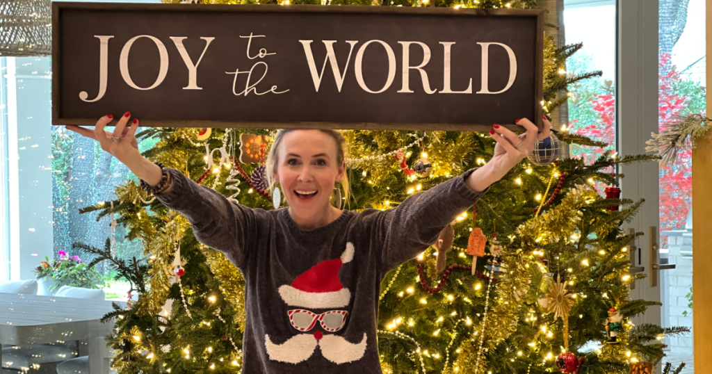 woman holding up "Joy to the World" sign 