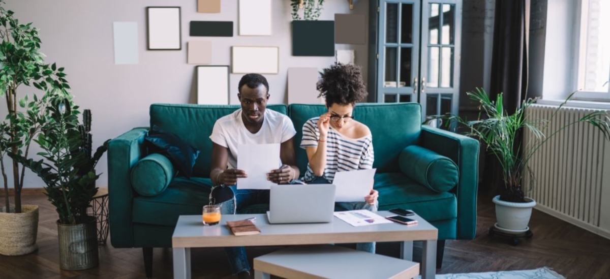 how to write a will with witnesses a couple on couch with laptop and papers