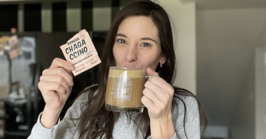 woman drinking mushroom coffee and holding a Renude Chagaccino packet