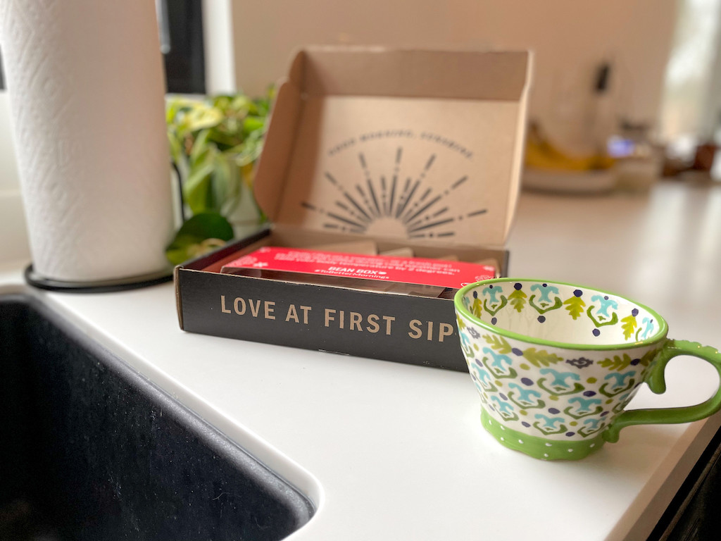 Bean Box subscription box with colorful coffee mug on counter 