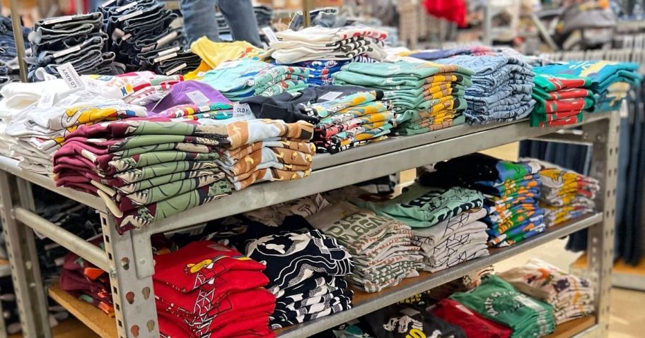 rows of Old Navy tees on a table