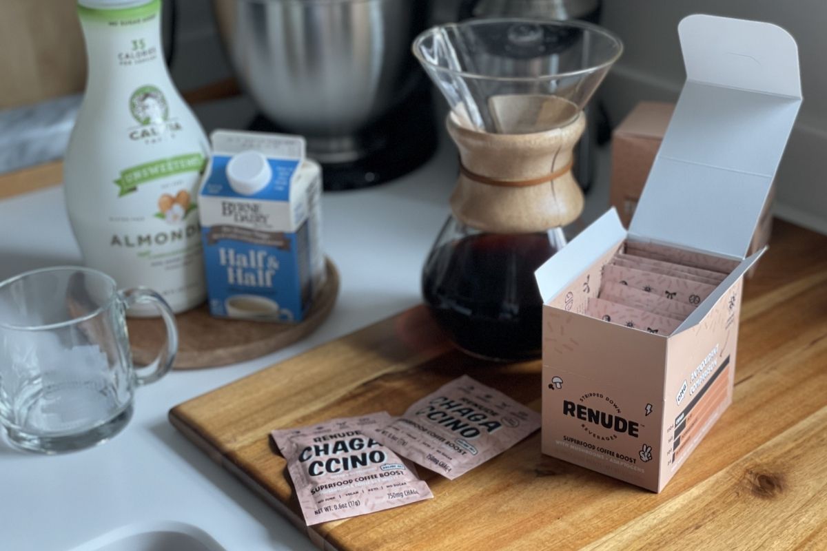 mushroom coffee packs, milk, and pour-over coffee maker on counter