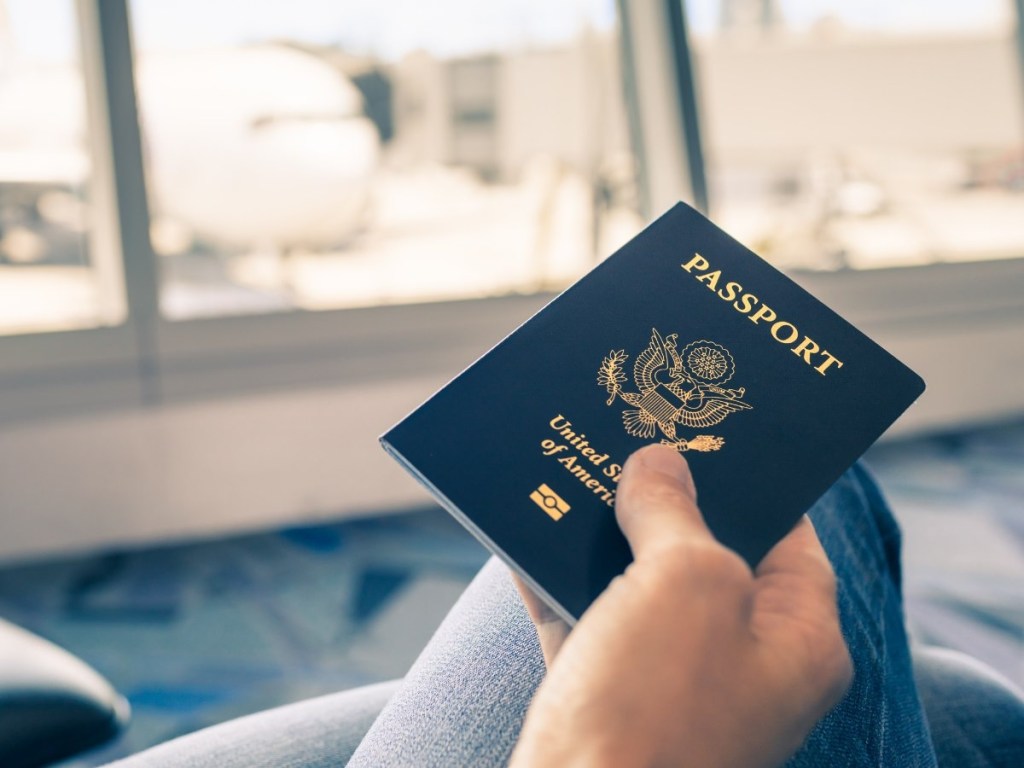 holding a passport at the airport