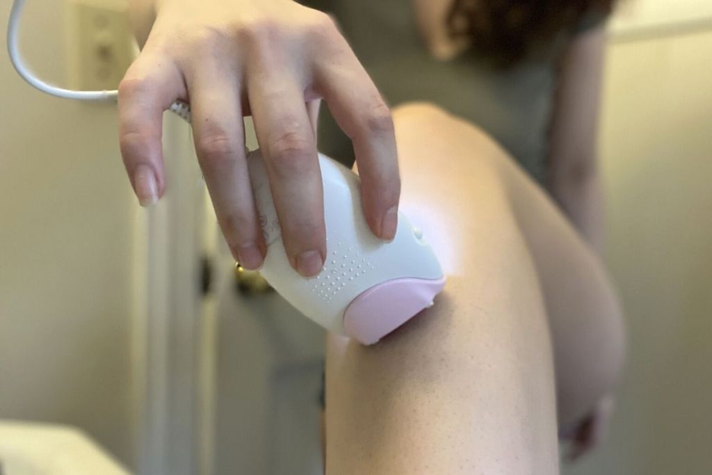 woman using Braun hair removal device