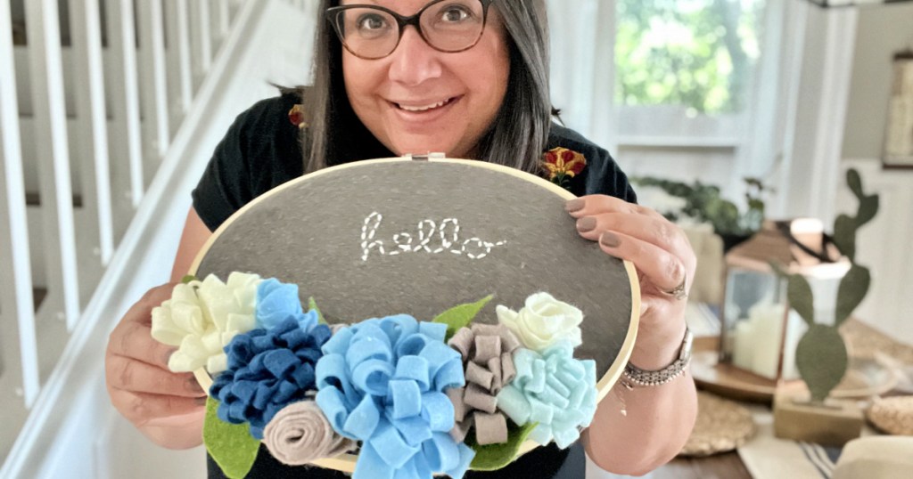 woman holding annie's crafts floral hoop after making