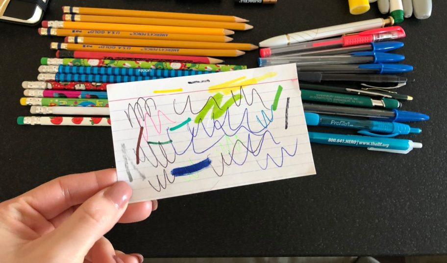 Testing pens on an index card to verify they work