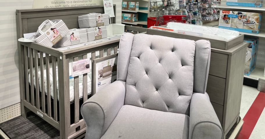 crib, chair and changing table in store on display