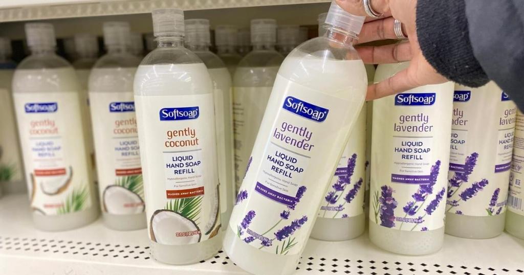 hand holding softsoap liquid handsoap refills on shelf