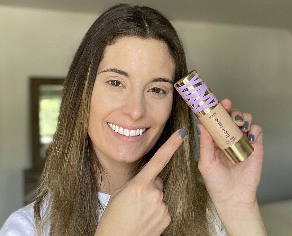 woman pointing at foundation bottle