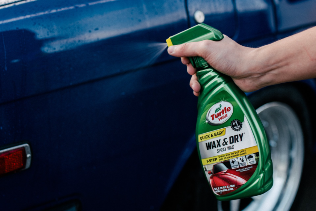 hand holding a bottle of Turtle Wax Wax and Dry Spray