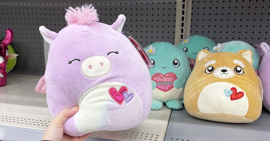 holding purple unicorn squishmallow