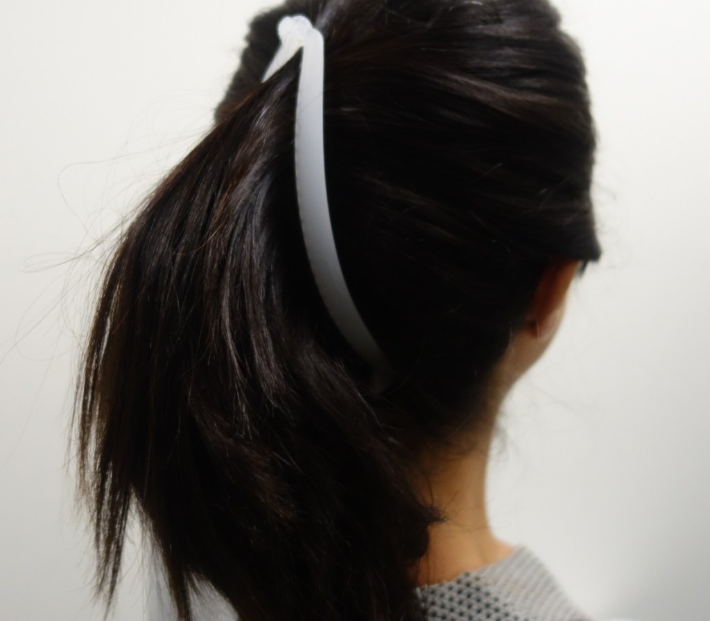 woman with dark hair wearing white banana clip