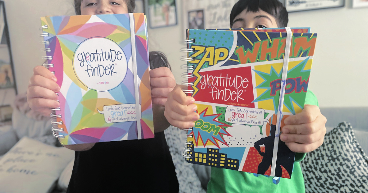 kids holding up their gratitude journals