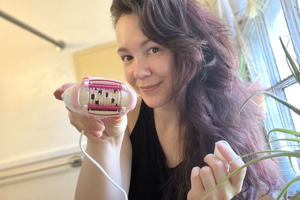 woman holding a hair removal device