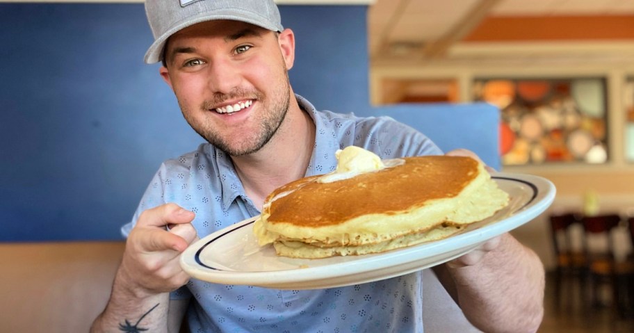 ihop plate of pancakes in mans hand