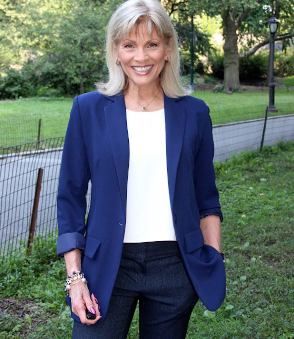 women wearing navy blazer standing outside on grass smiling