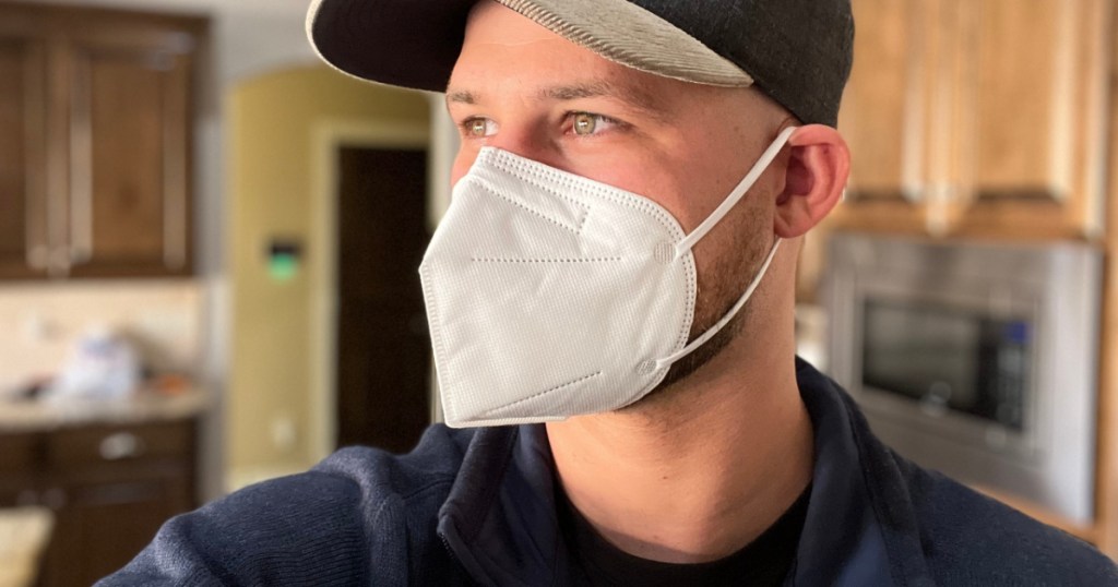 man standing in profile wearing a kn95 mask