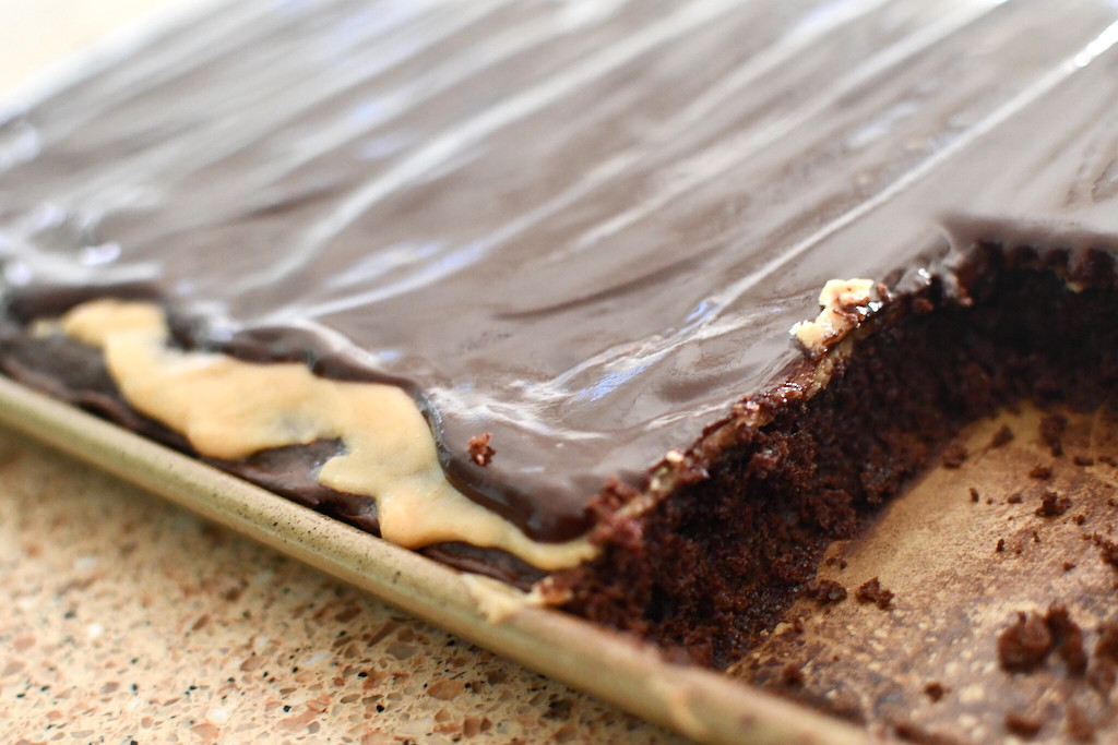 Texas sheet cake in pan with slice taken out