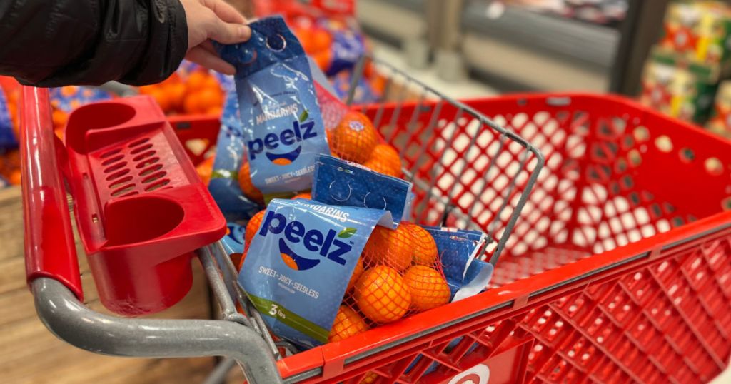 hand grabbing bag of oranges 