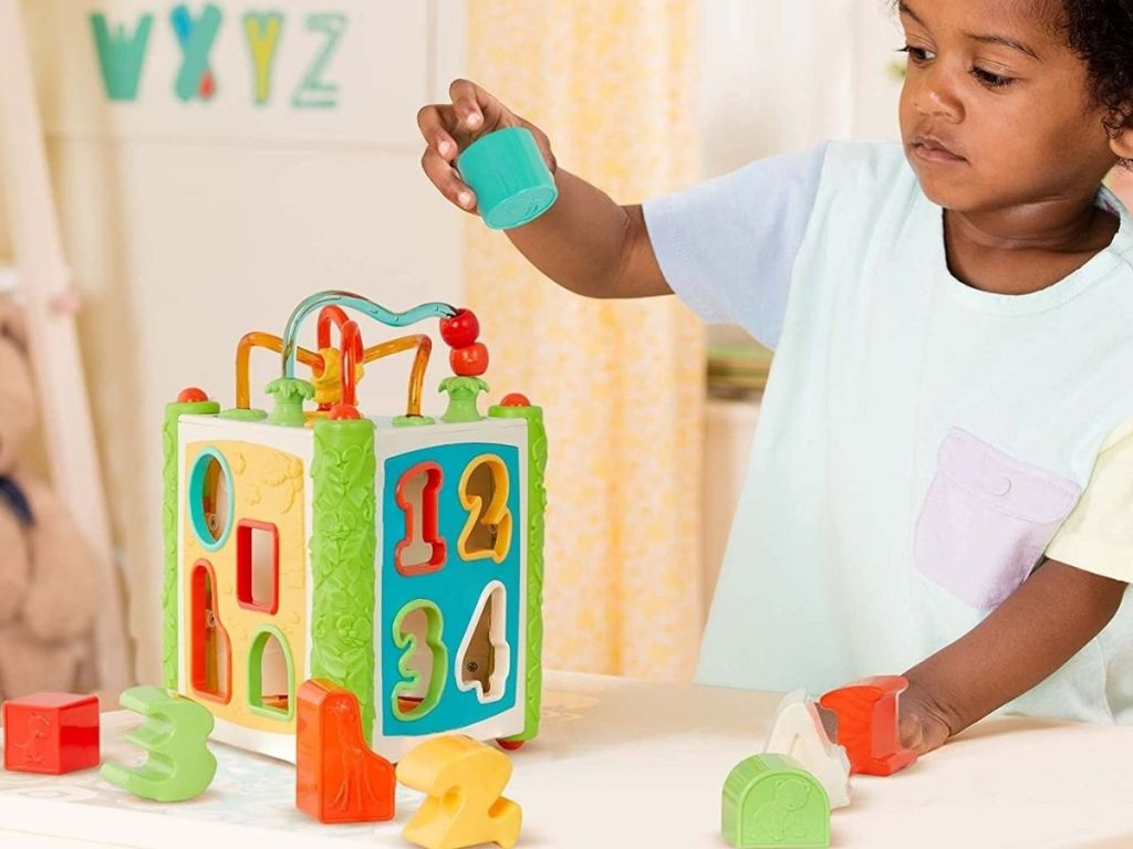 Little boy playing with Battat Shape Sorter Toy