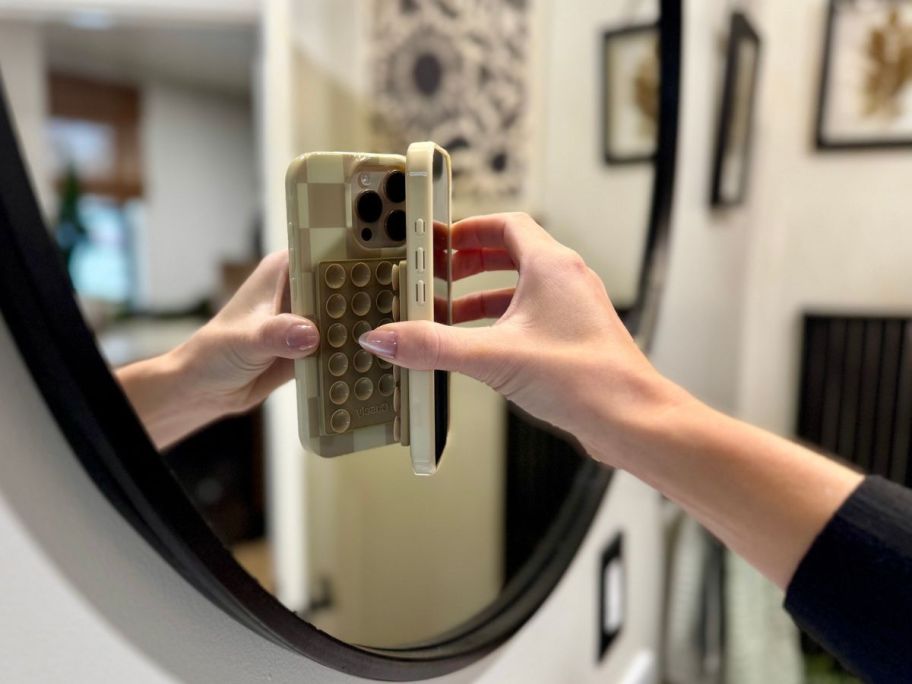 A Casely Grippy Phone Holders on a mirror