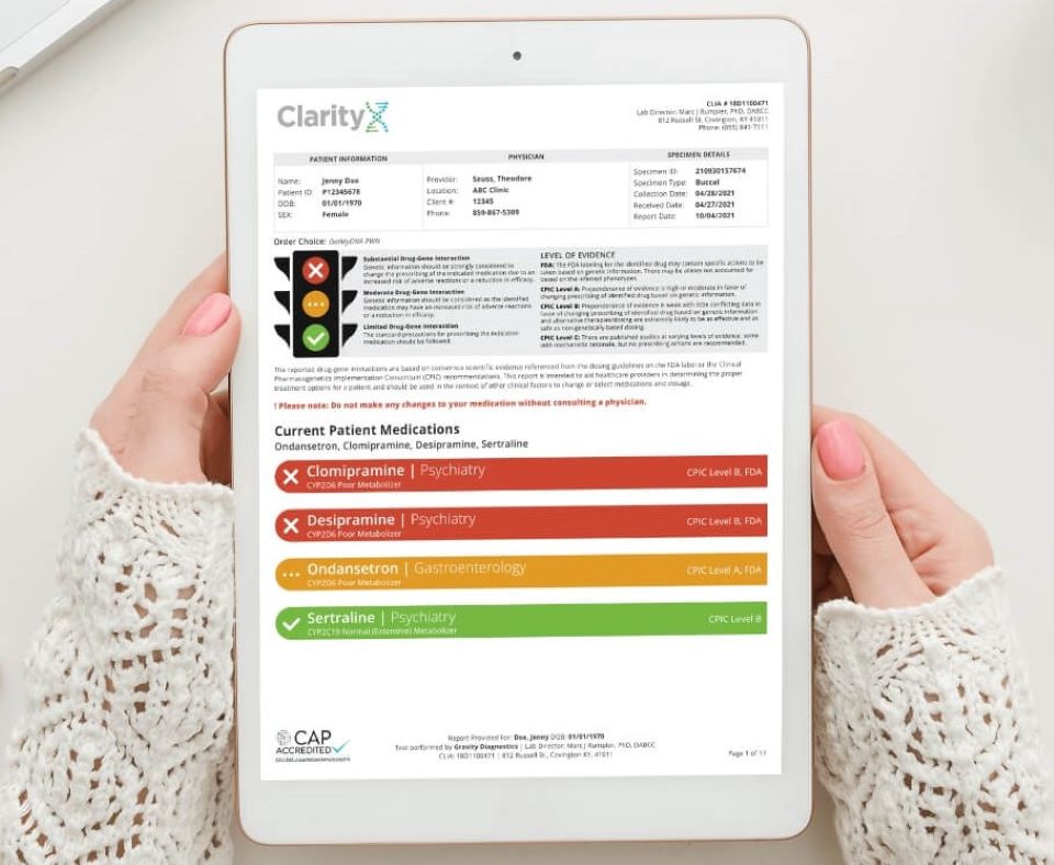 person holding a tablet with a DNA report on it