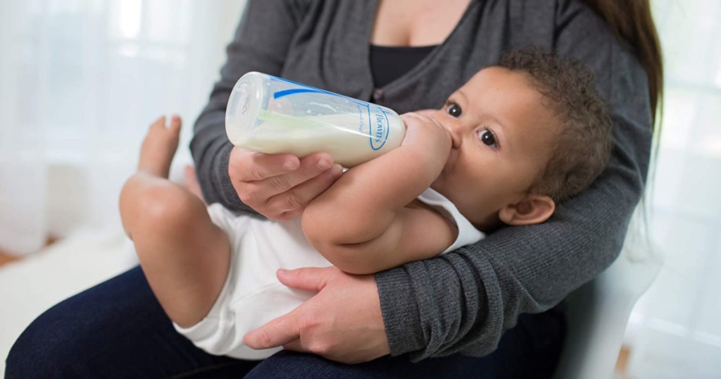 baby holding Dr Brown bottle