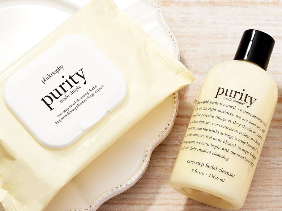 pack of Philosophy Purity Made Simple cleansing cloths and bottle of cleanser on plate and wood table