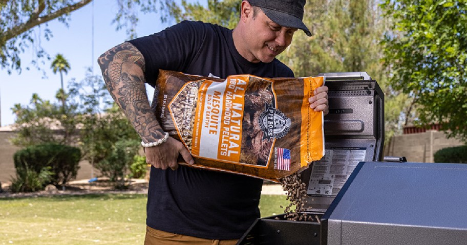 man pouring pit boss pellets in smoker 