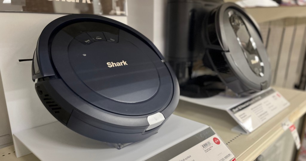 black robot vacuum on shelf 