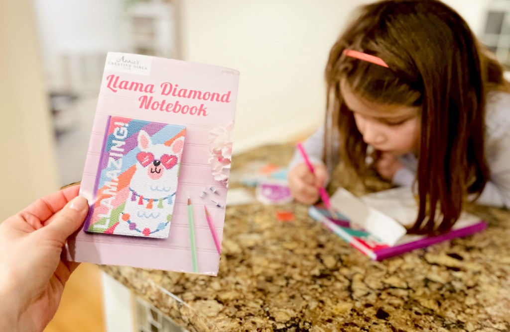 hand holding a pamphlet with llama notebook craft 