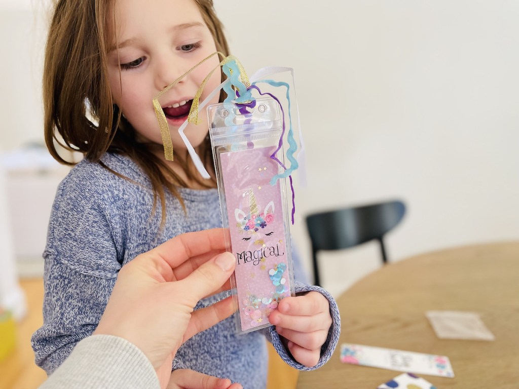 girl holding confetti bookmark 