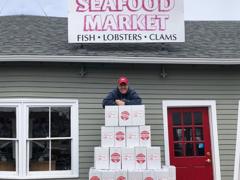 man with stacked goldbelly boxes