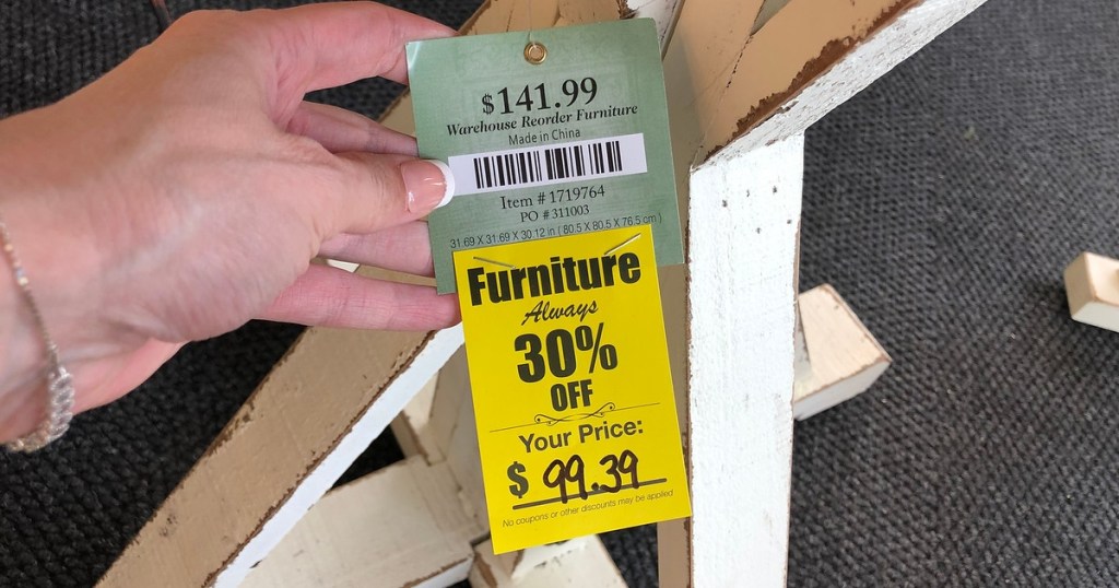 holding a Hobby Lobby price tag