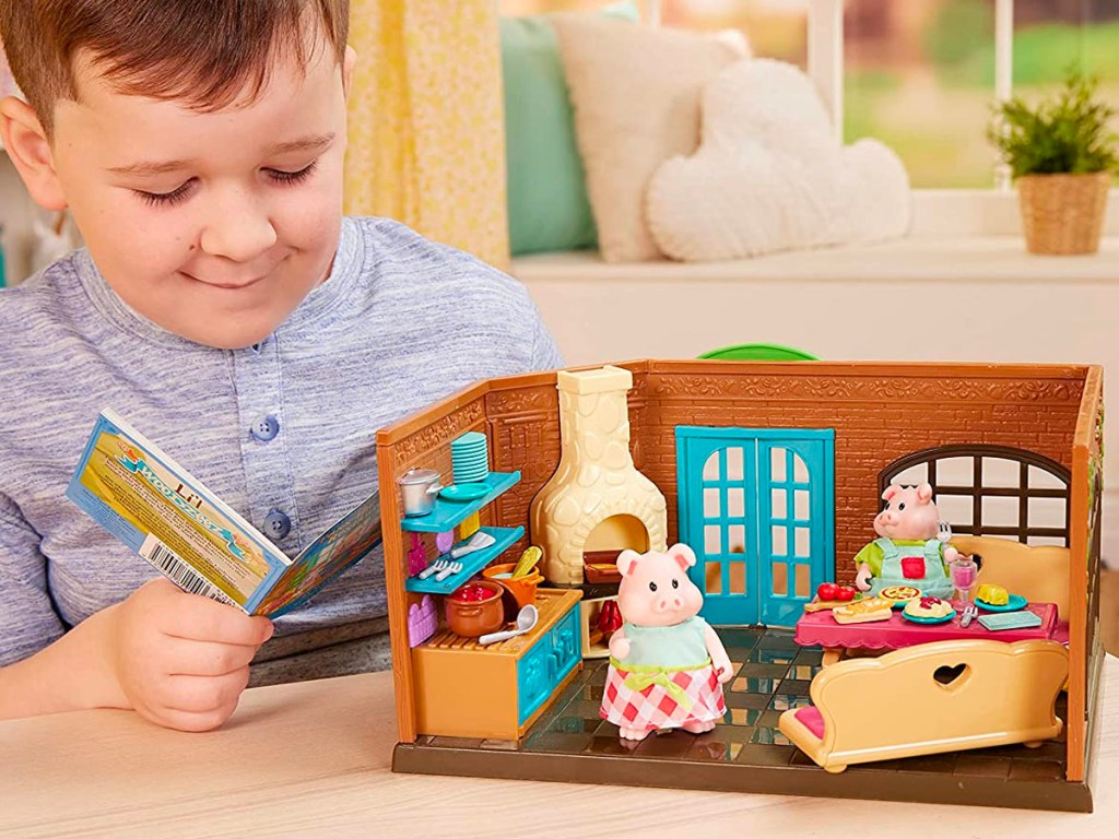 boy playing with lil woodzeez playset