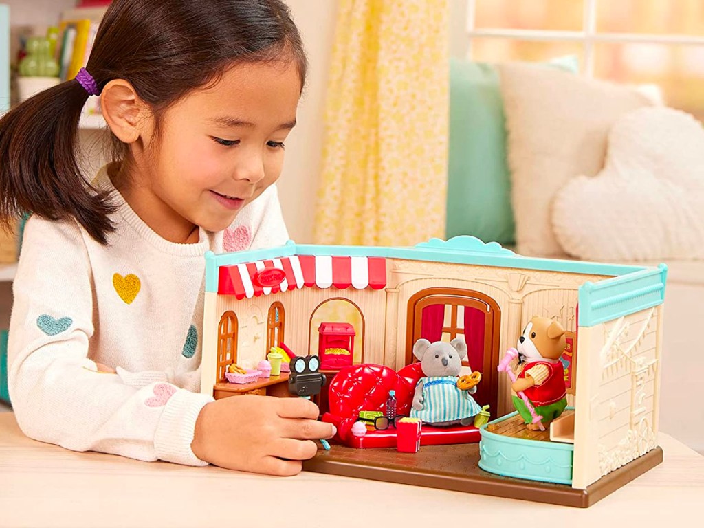 girl playing with lil woodzeez playset