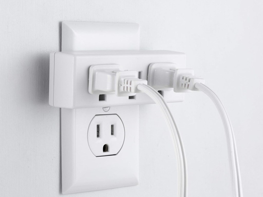 wall outlet with plugged in electronics attached to it