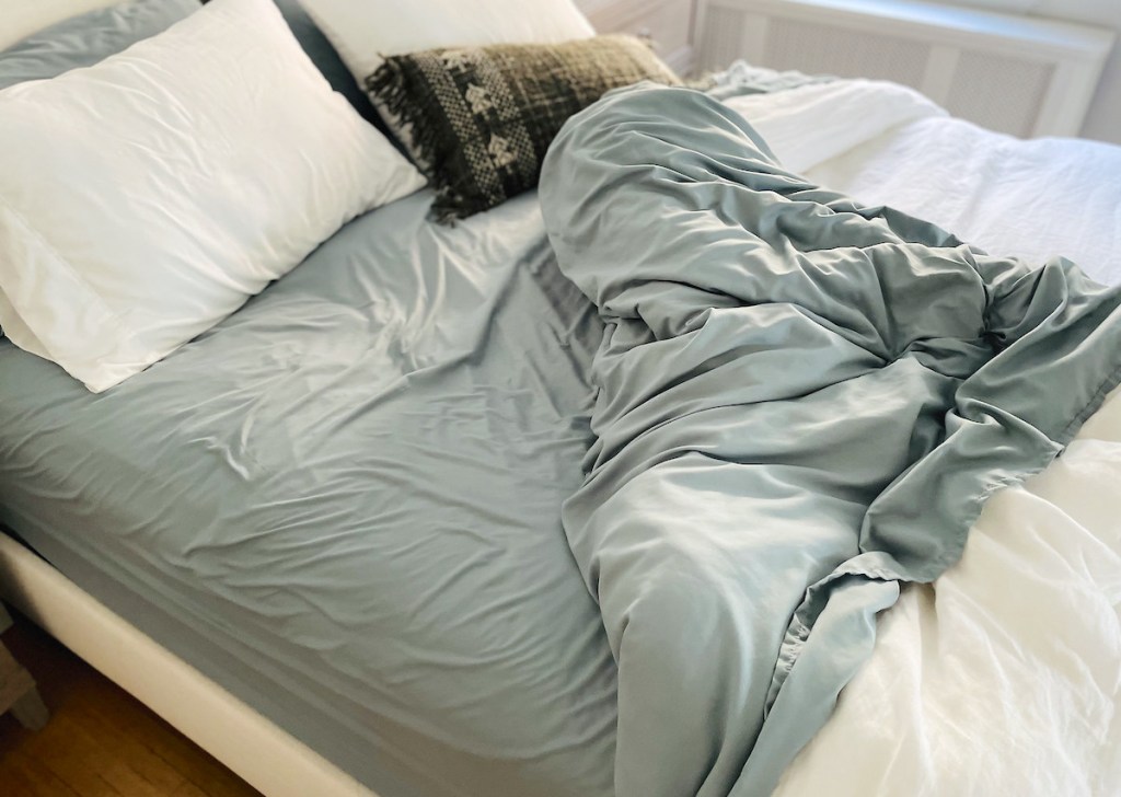 messy close up of bed with pillows and blankets