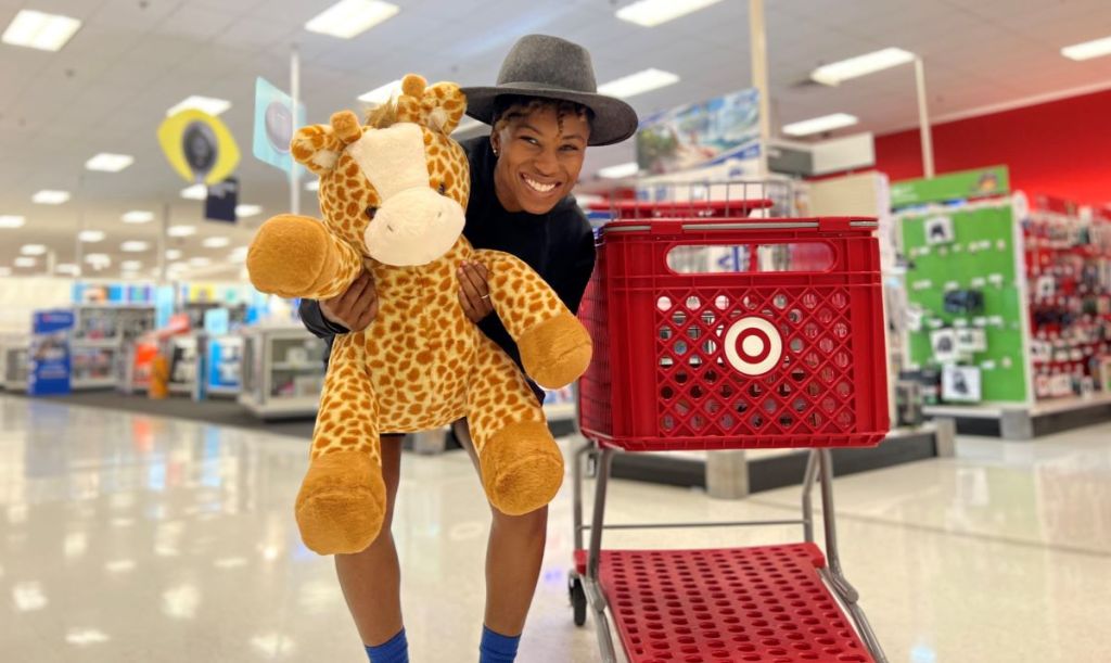 woman holding a plush giraffe