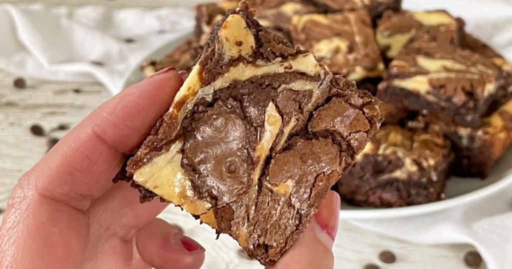 holding a cream cheese brownie 