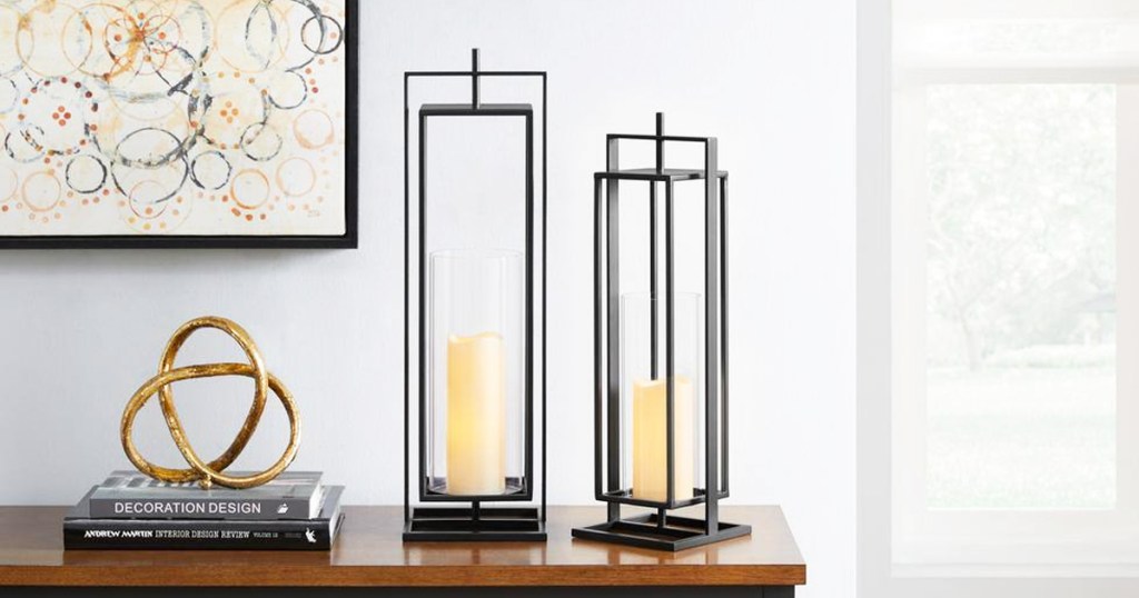 two black rectangular lanterns on wood table near books