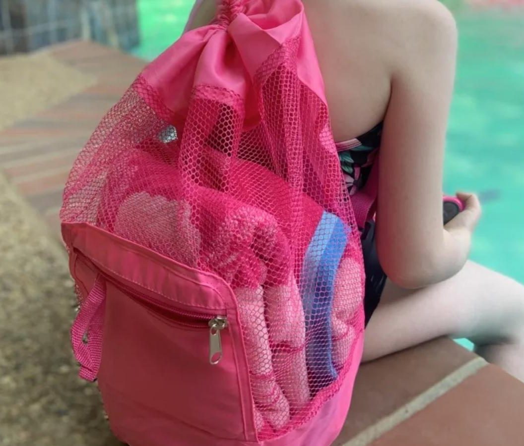 girl wearing pink foldable mesh backpack