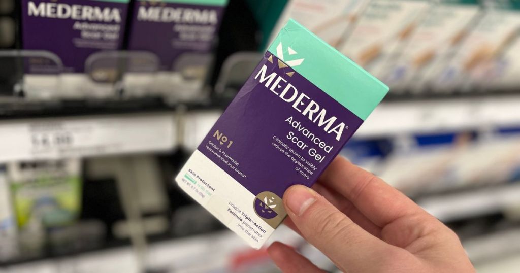 hand holding a Mederma Scar Gel