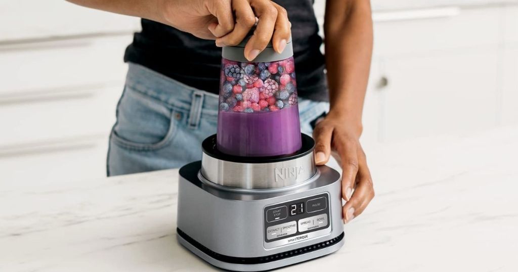 woman using a Ninja Blender